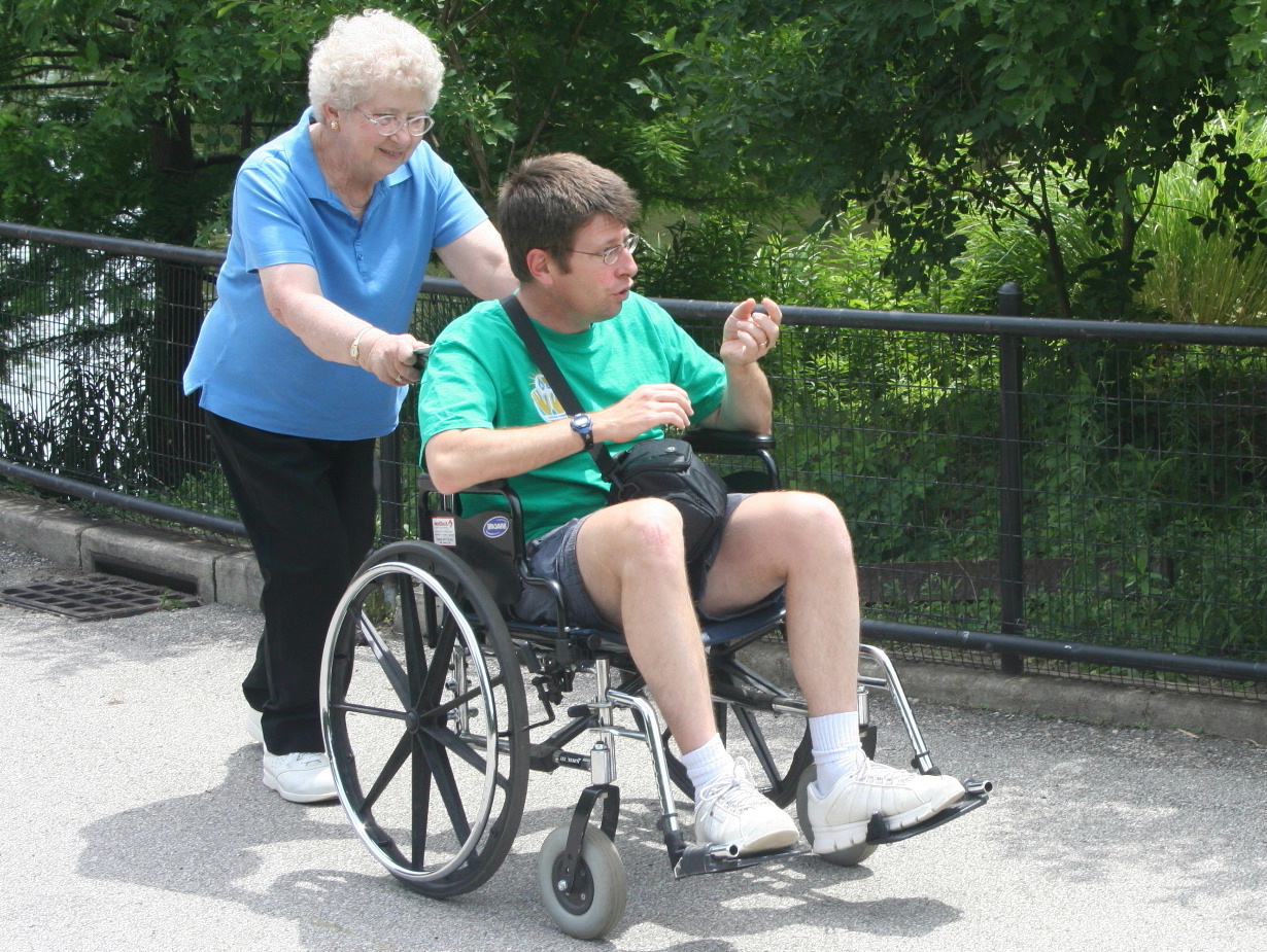 Mom pushing Michael in wheelchair
