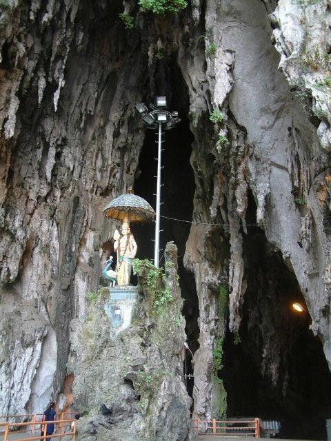 Interior of Batu Cave soars above Subrahmanya Swami Kovil>>>